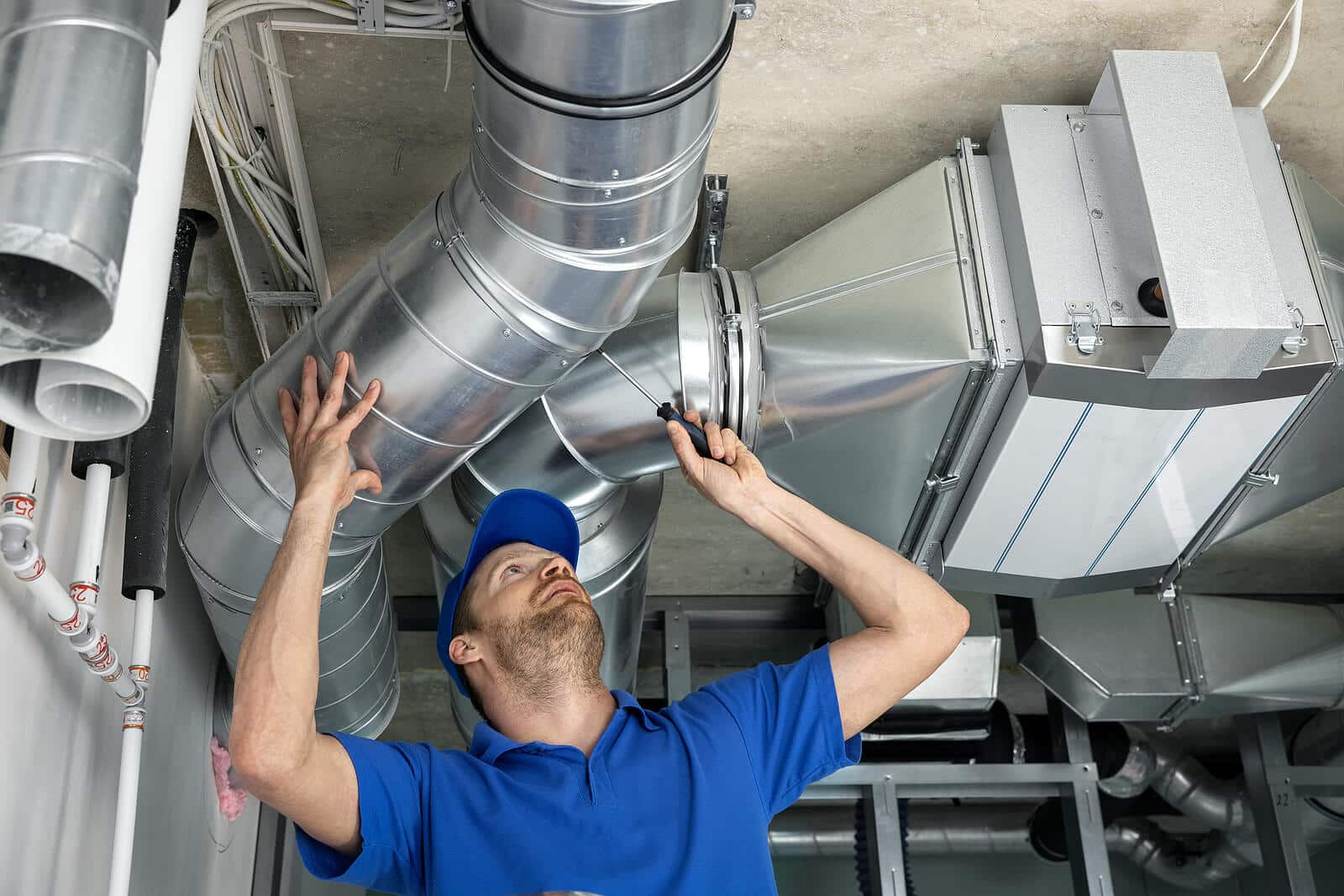 HVAC technician inspecting and repairing air ducts in Stevenson Ranch