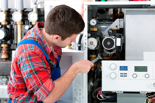 Heating technician repairing boiler controls in Stevenson Ranch