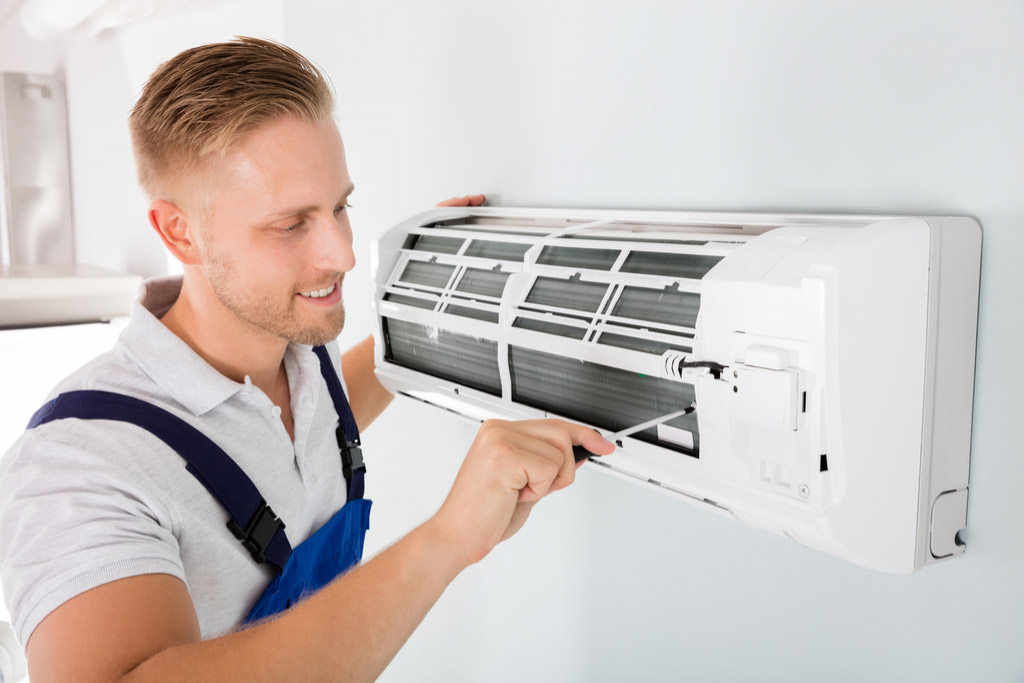 HVAC technician maintaining a ductless air conditioner in Stevenson Ranch