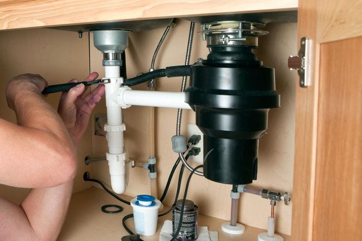 Plumber repairing a garbage disposal in Stevenson Ranch