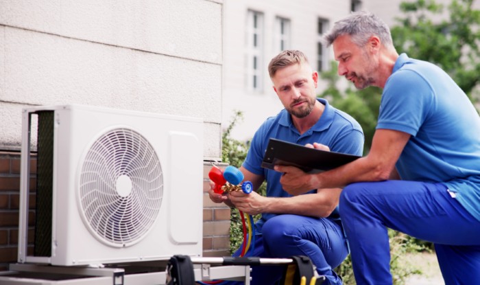 HVAC technicians installing an outdoor air conditioning unit in Stevenson Ranch