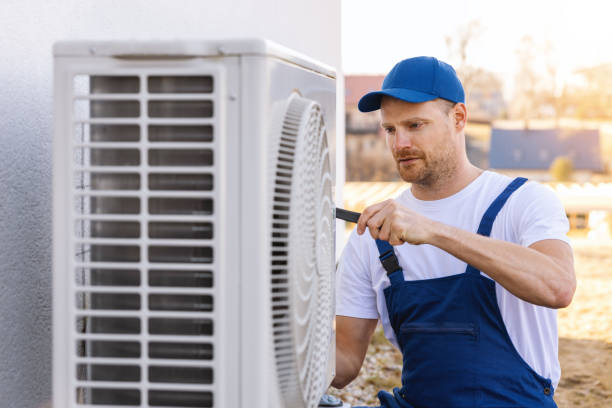 HVAC technician servicing an outdoor air conditioner in Stevenson Ranch